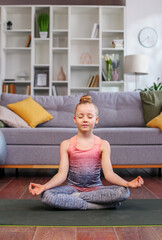 Little girl meditate. Child do yoga, breathing exercise, relax alone with closed eyes in lotus pose.