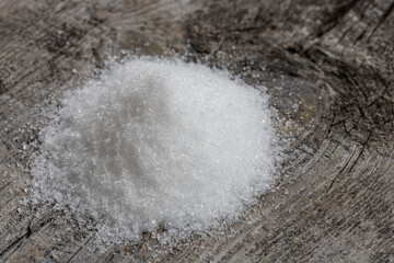 Crystal white granulated sugar. Crystal sugar photos on wood for diabetics to stay away from