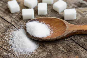 Fototapeta na wymiar Crystal white granulated sugar. Crystal sugar photos on wood for diabetics to stay away from