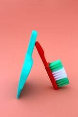 On a light background lies a brush and a scoop for cleaning green.
