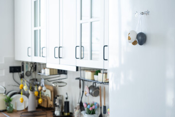 Interior of kitchen and details of decor of utensils with Easter decoration of colorful eggs in a loft style. Festive interior of a country house