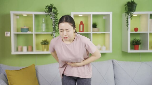 Asian young woman with abdominal pain has an umbilical hernia.
Young Asian woman with severe and prolonged abdominal pain has an umbilical hernia.
