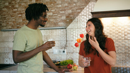 Closeup young couple talk and drink stand at kitchen