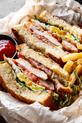 Club sandwich with French fries and sauce