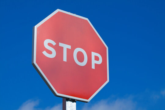Close-up of a stop Sign against a blue sky