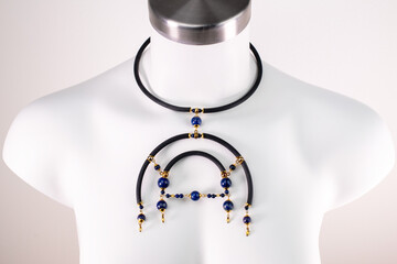 Statement unique black bib necklace on a white mannequin, massive unusual handmade jewelry