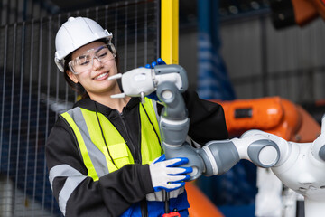 A team of  female engineers meeting to inspect computer-controlled steel welding robots. Plan for rehearsals and installation for use.