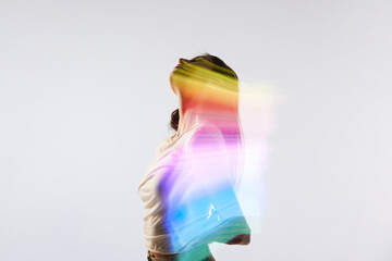 Aspiration. Silhouette portrait of young adorable woman posing over white background with mixed neon colored light on her body. Concept of contemporary art, fashion, futurism
