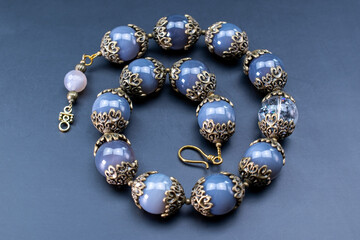 Colorful gemstone crystal beads necklace on black, unique handmade jewelry background