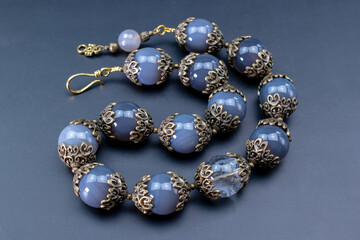 Colorful gemstone crystal beads necklace on black, unique handmade jewelry background