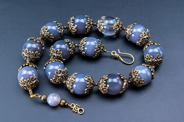 Colorful gemstone crystal beads necklace on black, unique handmade jewelry background