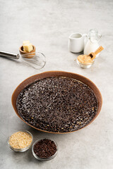 Martabak manis or terang bulan is indonesian sweet pancake, with brown color and filled with chocolate chips, cheese, fruit jam, butter and peanut on concreate background.