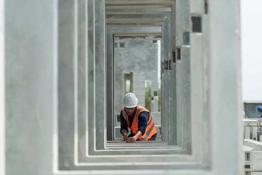 Male engineers are inspecting and controlling the work of the employees and the quality of the manufactured products to meet the standards In industrial factories producing precast prefabricated walls