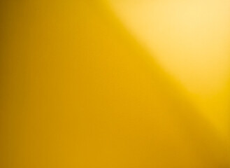 Obraz premium Shiny gold polished metal background texture of brushed stainless steel plate with the reflection of golden light.