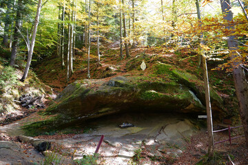 Blessed Stone and sacred spring in forest near Manyava Skete in Ukraine