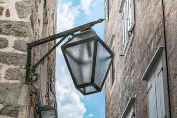Antique street lamp in the Old Town Stari Grad in Budva, Montenegro. A forged steel streetlight...