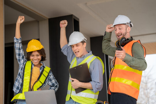 Team of architects and colleagues of various nationalities smile happily at success. Teamwork and professional colleagues: the hands of workers. Teamwork concept.