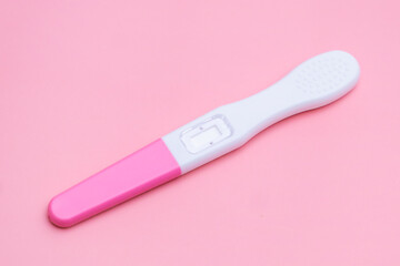 Pregnancy test isolated on the pink background. Healthcare concept 