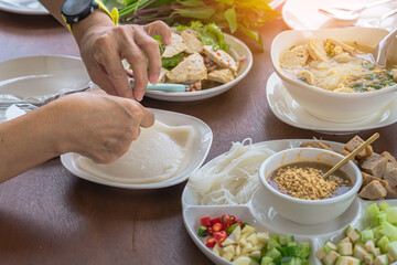 Enjoy eat with Vietnamese Meatball Wraps (Nam-Neung), Pork Sausage wraps with fresh vegetables in rice paper, generous platter eat with sweet sauce. Vietnamese Pork Sausage and salad. Selective focus.