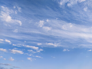 Blue sky with beautiful fluffy clouds; background of cloudy sky - 579072949
