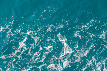 Top view from the ferry ship with sea wave with white foam or bubble in wavy or spiral pattern, Stop motion of water splashing during the boat is sailing with copy space, Nature texture background.