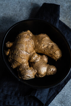 Overhead view of a bowl with a fresh ginger root