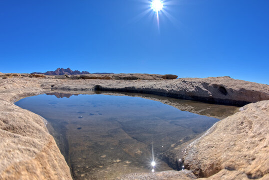 Sunburst Over Rock Pool At Johnson Point, Glen Canyon National Recreation Area, Arizona, USA