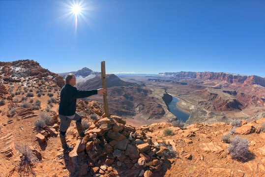 Hiker standing at the end of the Spencer Trail overlooking Lee's Ferry along the Colorado River in Glen Canyon Recreation Area of Marble Canyon, Arizona, USA