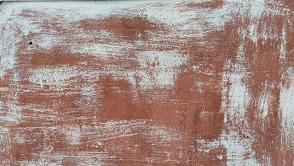A metal plate with red rust and white paint. Background and texture