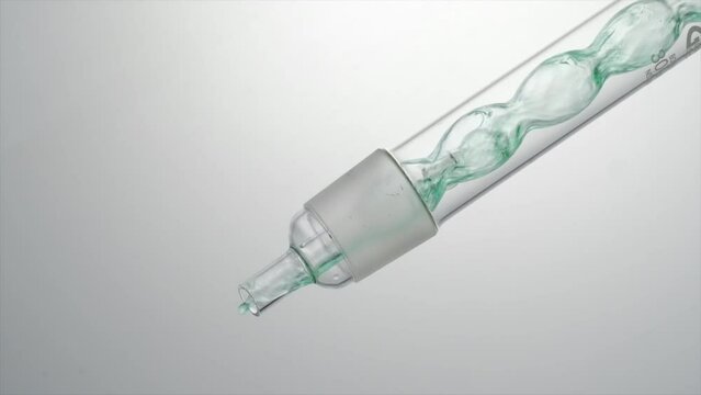 A close view of the yellow liquid passes through the test tube and flows out. science laboratory research and development concept
