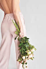 Beautiful young woman with bouquet flowers of roses. International Women's Day.