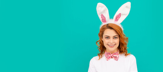 happy easter woman in bunny ears and bow tie on blue background. Woman isolated face portrait,...