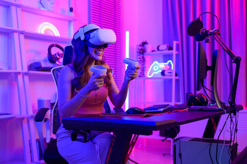Young Asian pretty woman Pro Gamer have live streaming  playing video game,  using virtual reality glasses at home