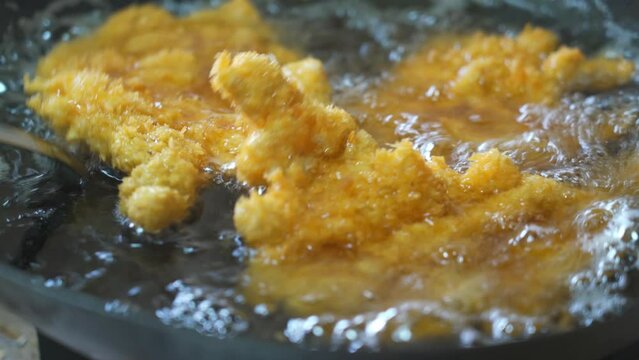 A chef is making deep-fried cutled  Pork and fried cutled Chicken