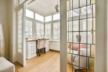 a living room with wood flooring and white shutters on the windows looking out onto an area with...