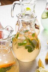 Closeup on jars of assorted variety of fresh fruit lemonades