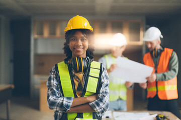 Foreman builder woman at construction site. American African foreman construction standing at...