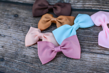 Pastel colors hair bows on dark wooden background
