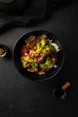 Bowl of asian cooked rice with beef and vegetables