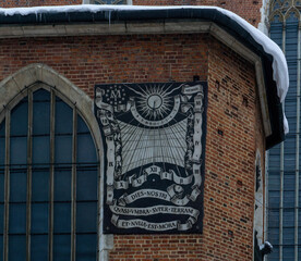 Wall sundial on the brick wall of the ancient St. Mary's Cathedral in Krakow