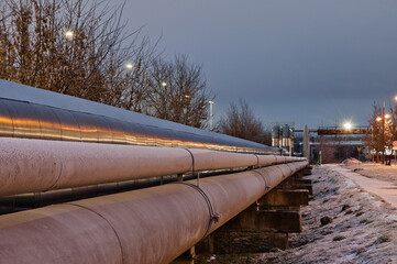 pipeline in the evening, in the background a gray sky and spotlights