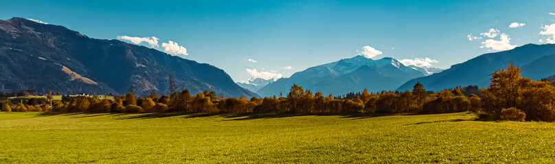 Alpine autumn or indian summer view with the Hohe Tauern mountains  in the background near...