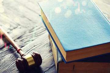 Wooden judge gavel and legal book on wooden table