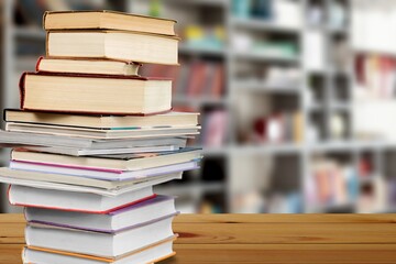 Stack of old shabby books on wooden desk