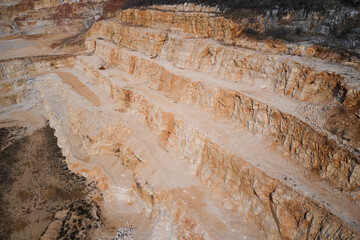 Red marble in a quarry. Panorama of an open pit in the mountains of Italy. Marble quarry in Italy.