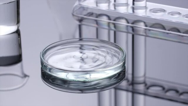 A close view of liquid pouring into surface of solution on petri dish, create small waves and bubbles, in white background.  Laboratory equipment , science content and background
