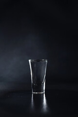 Close up of Glass of Vodka on a black background. Drink Transparent Glass on a black background. Isolate. Copy space