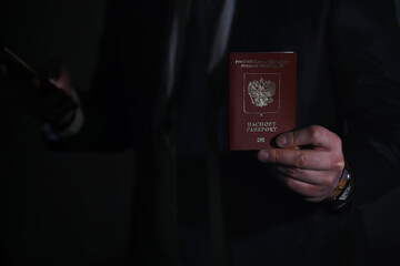 Traveling businessman handing russian passport