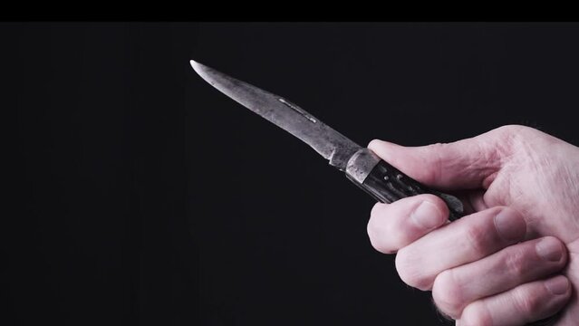 Tight shot of male hand brandishing  a pocketknife or jackknife