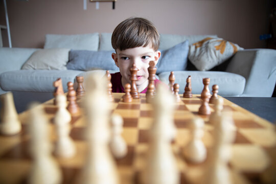Focused boy playing chess, strategy